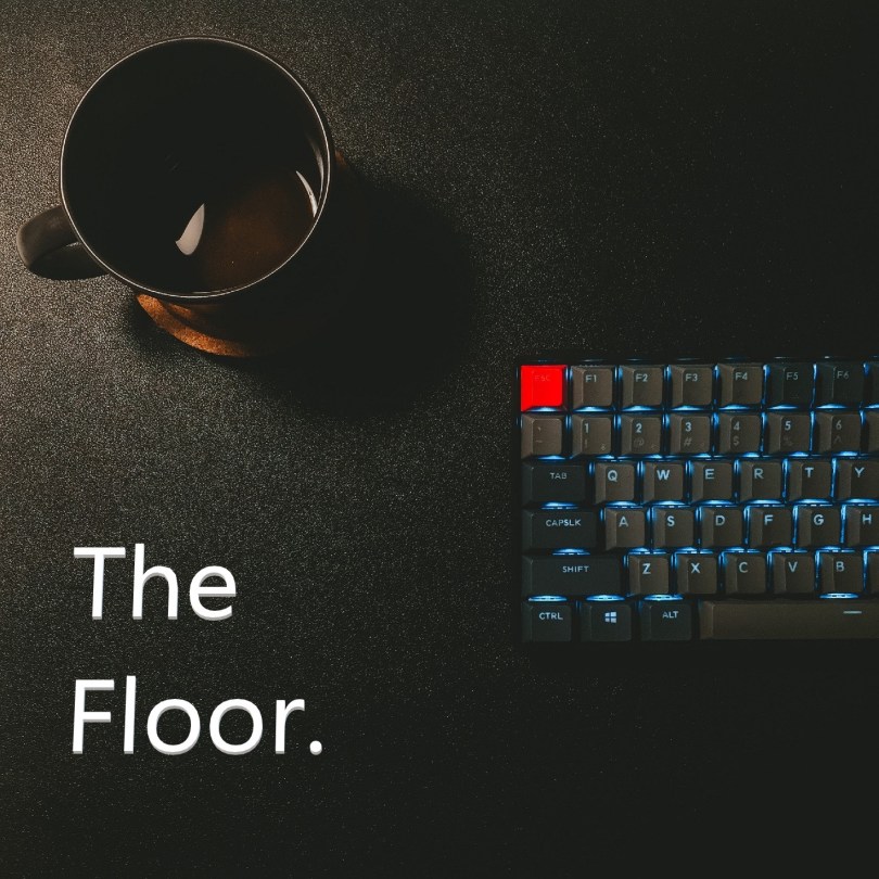 coffee cup and backlit computer keyboard with title 'The Floor'