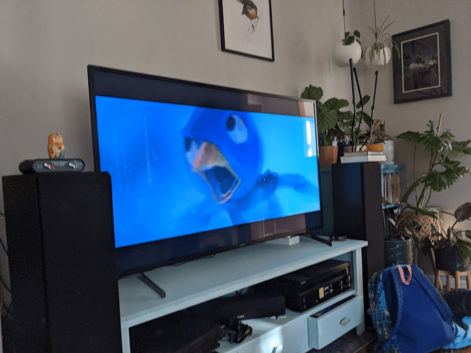 A living room television showing a still from the film Super Mario Brothers.